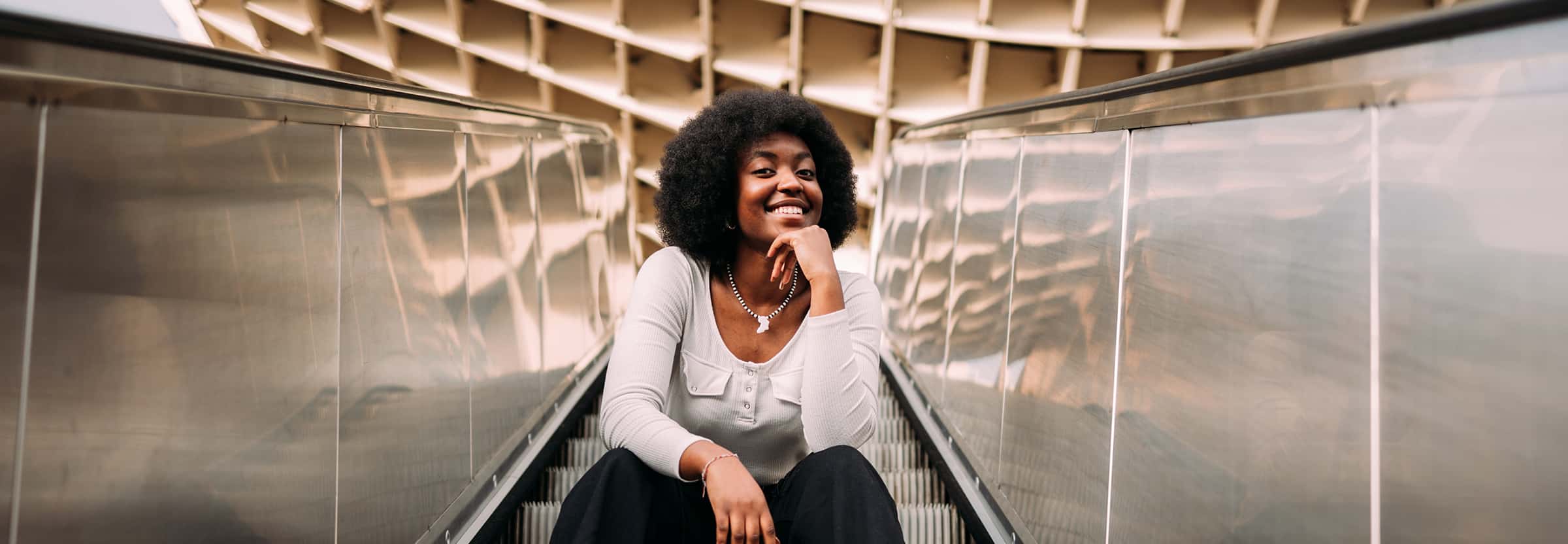 smiling woman on escalator