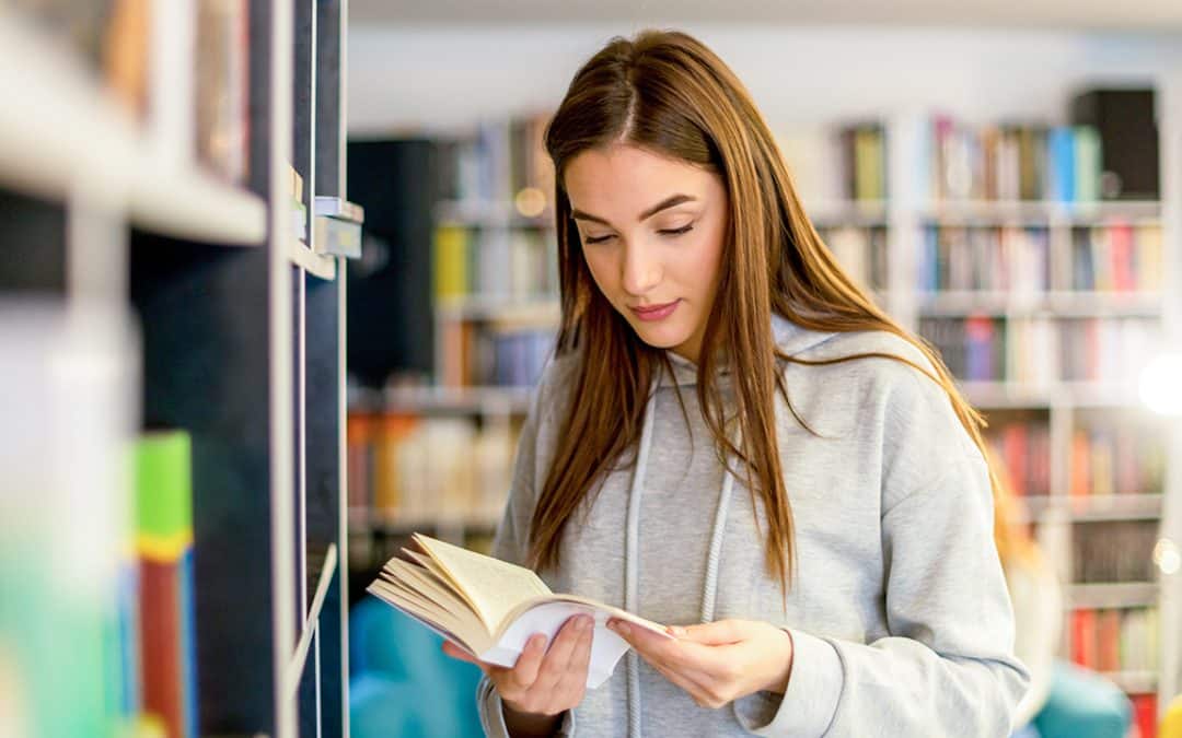 student reading book in library