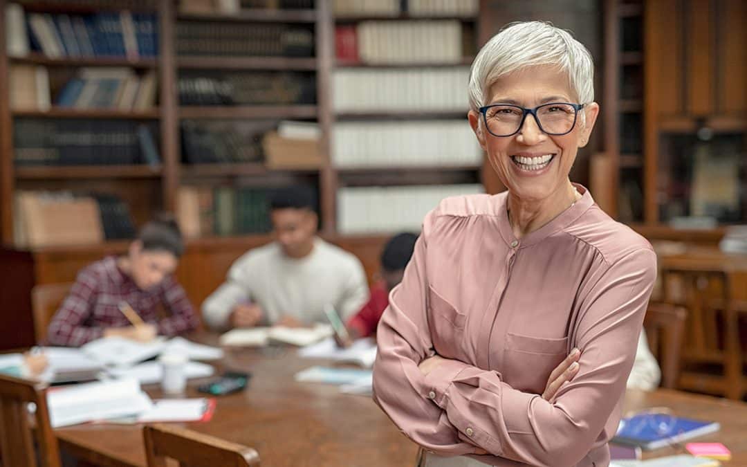 teacher and students in library