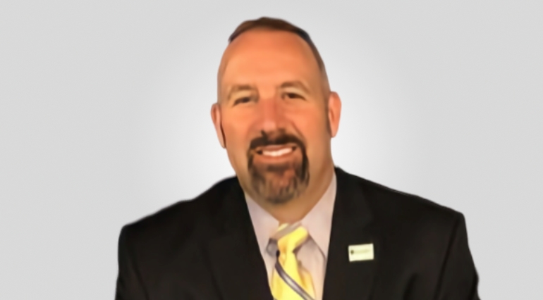 Man wearing black suit and yellow tie